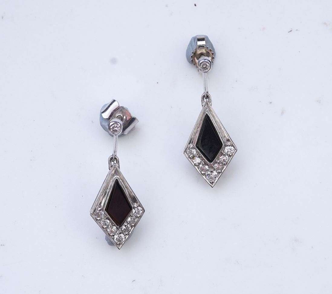 A pair of onyx and diamond earrings